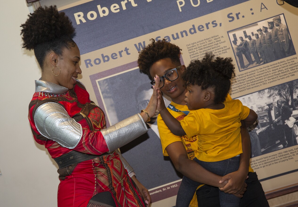 Okoye (Tahrita Davis) high fives a little fan.